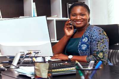 Young woman business owner on the phone in her home office.