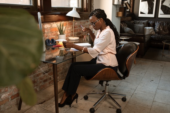 Young woman working at her home office desk.