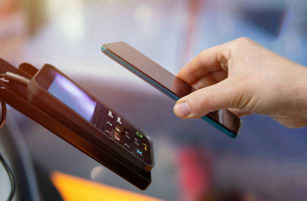 Picture of a customer making payment with their phone at the POS.