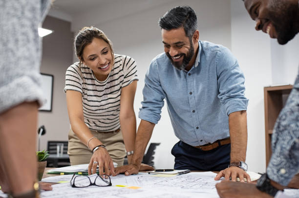 Pic of architects reviewing expansion blueprints with restaurant owners