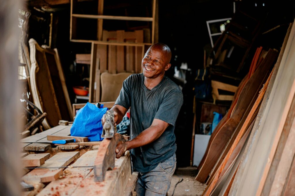 Pic of a black man furniture shop owner at work