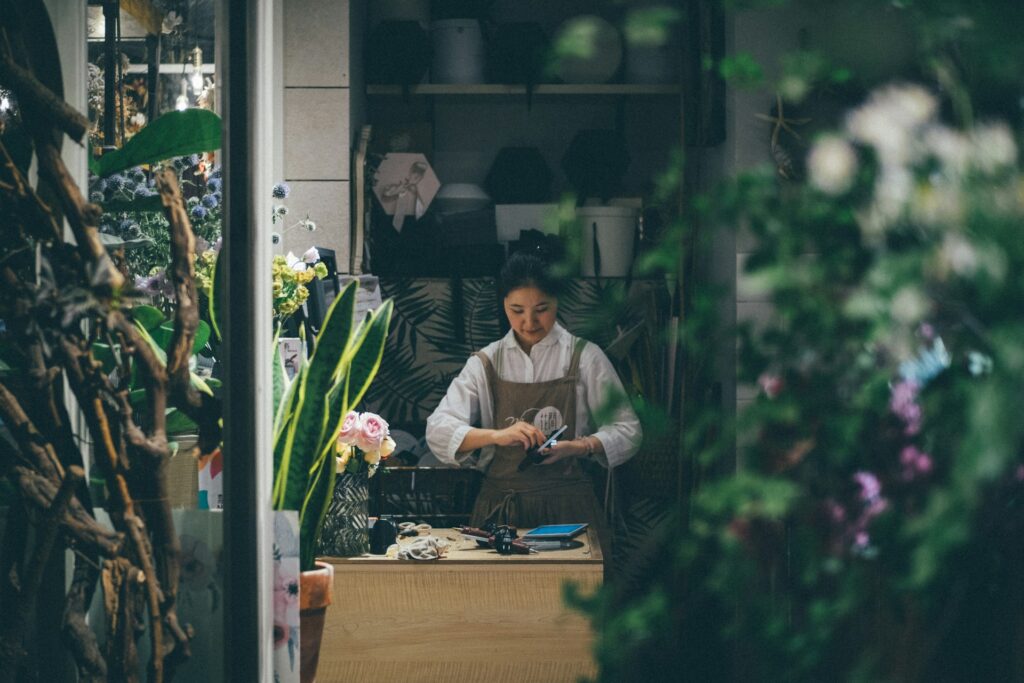 Pic of female flower shop owner working