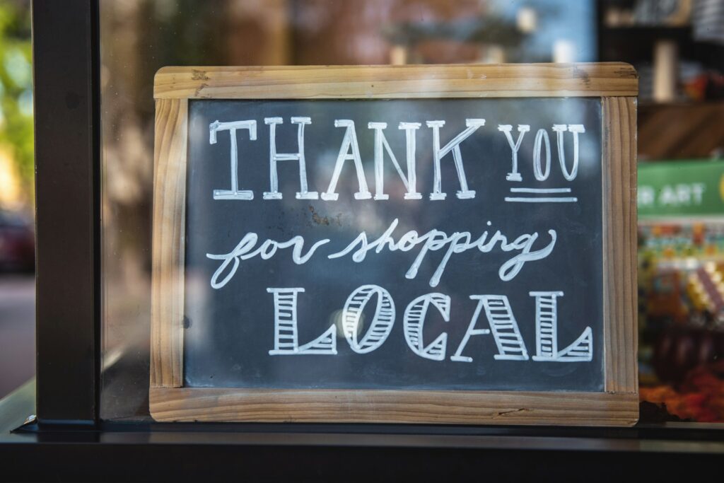 Pic of a small blackboard with thanks for shopping local written in white chalk.